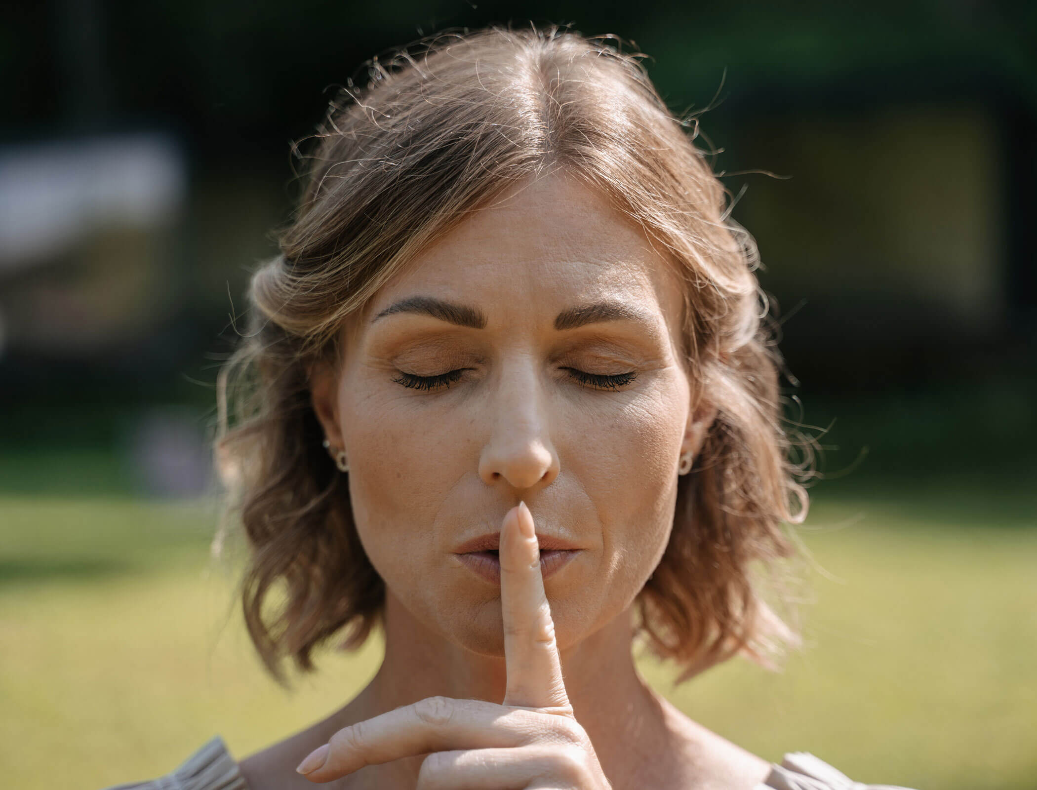 Woman puts finger to lips