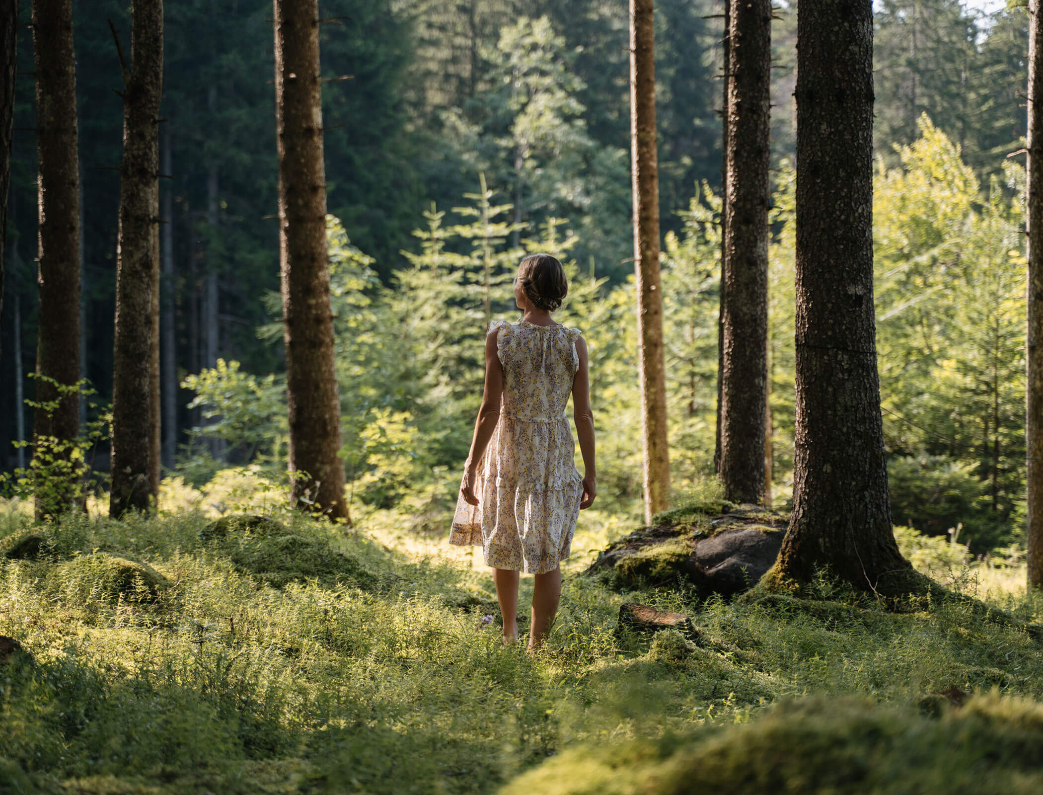 Woman in the forest gazing into the distance